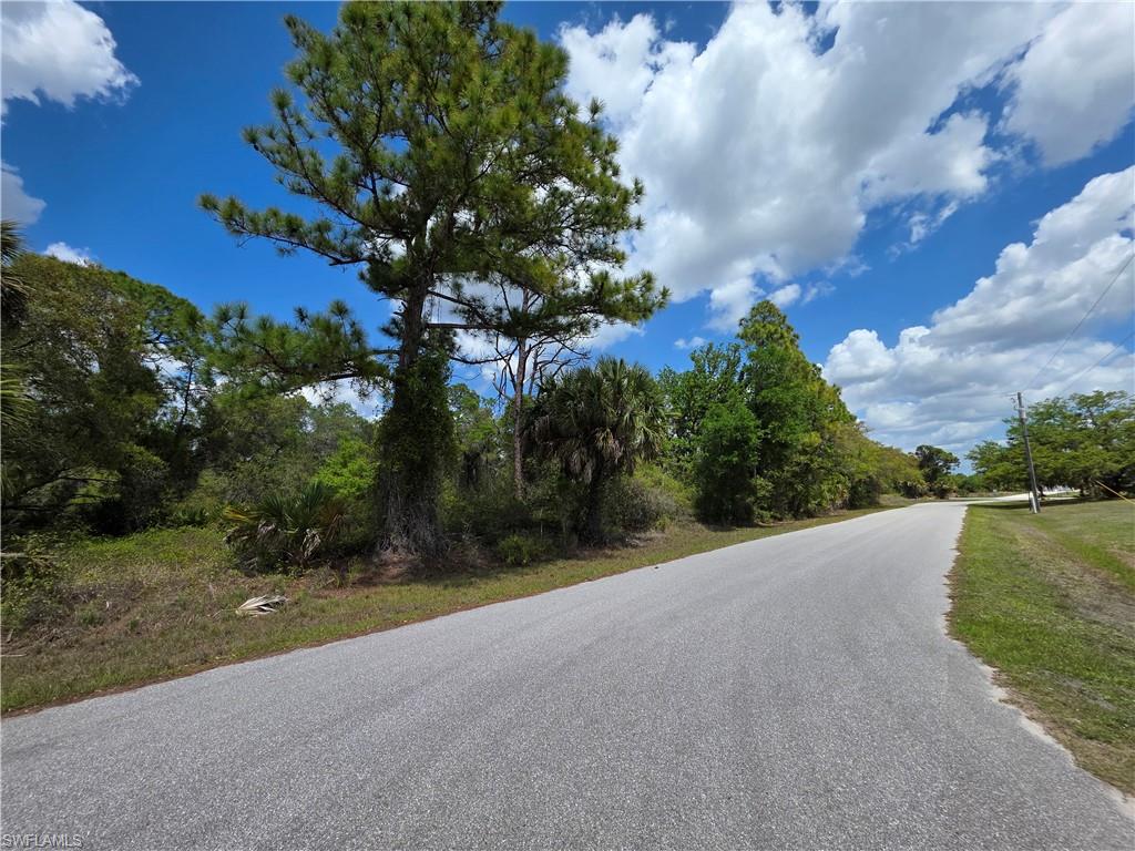 a view of a road with a big yard