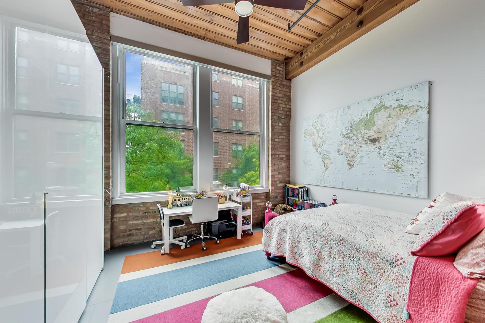 1327 West Washington Boulevard, Unit 2H Chicago, IL 60607 - Photo 18 of 31 a bed room with a bed and a chair