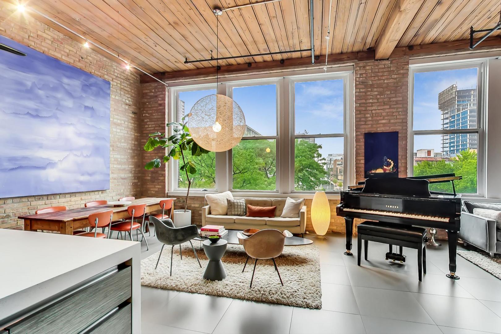 1327 West Washington Boulevard, Unit 2H Chicago, IL 60607 - Photo 2 of 31 a living room with patio furniture and a large window