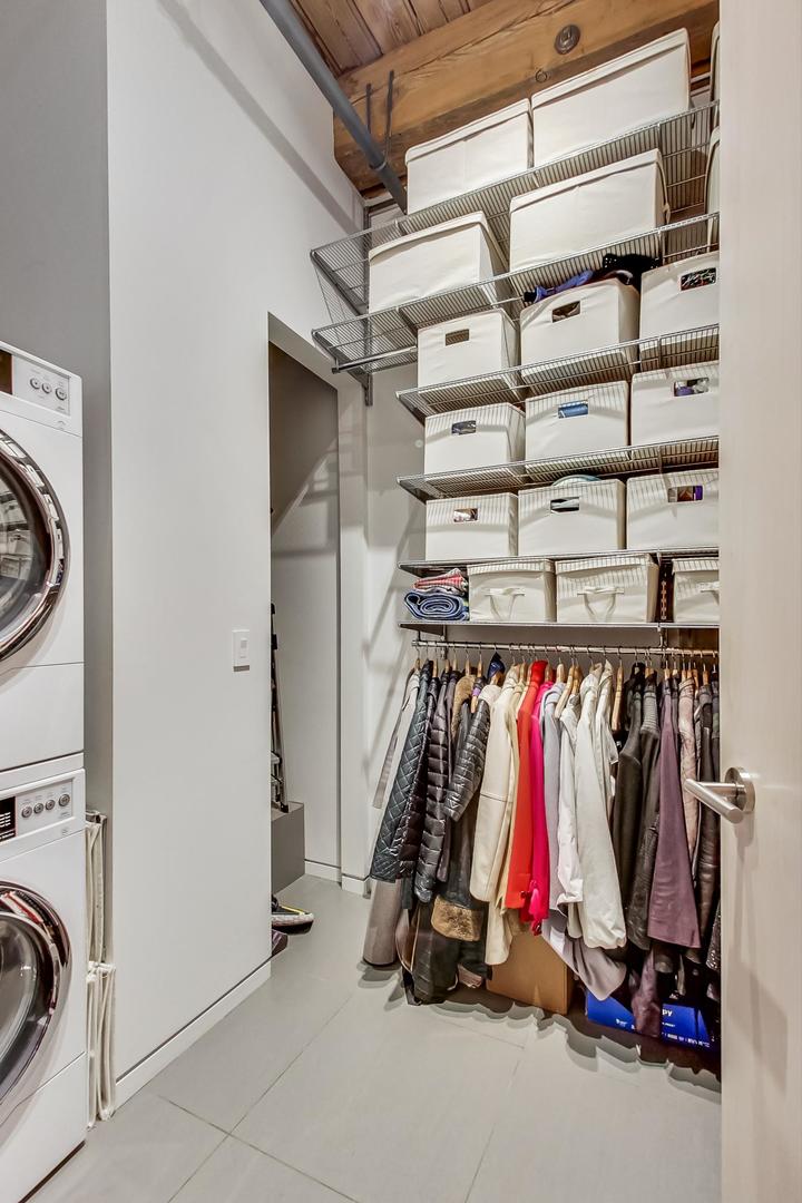 1327 West Washington Boulevard, Unit 2H Chicago, IL 60607 - Photo 21 of 31 a view of walk in closet with clothes and shoes