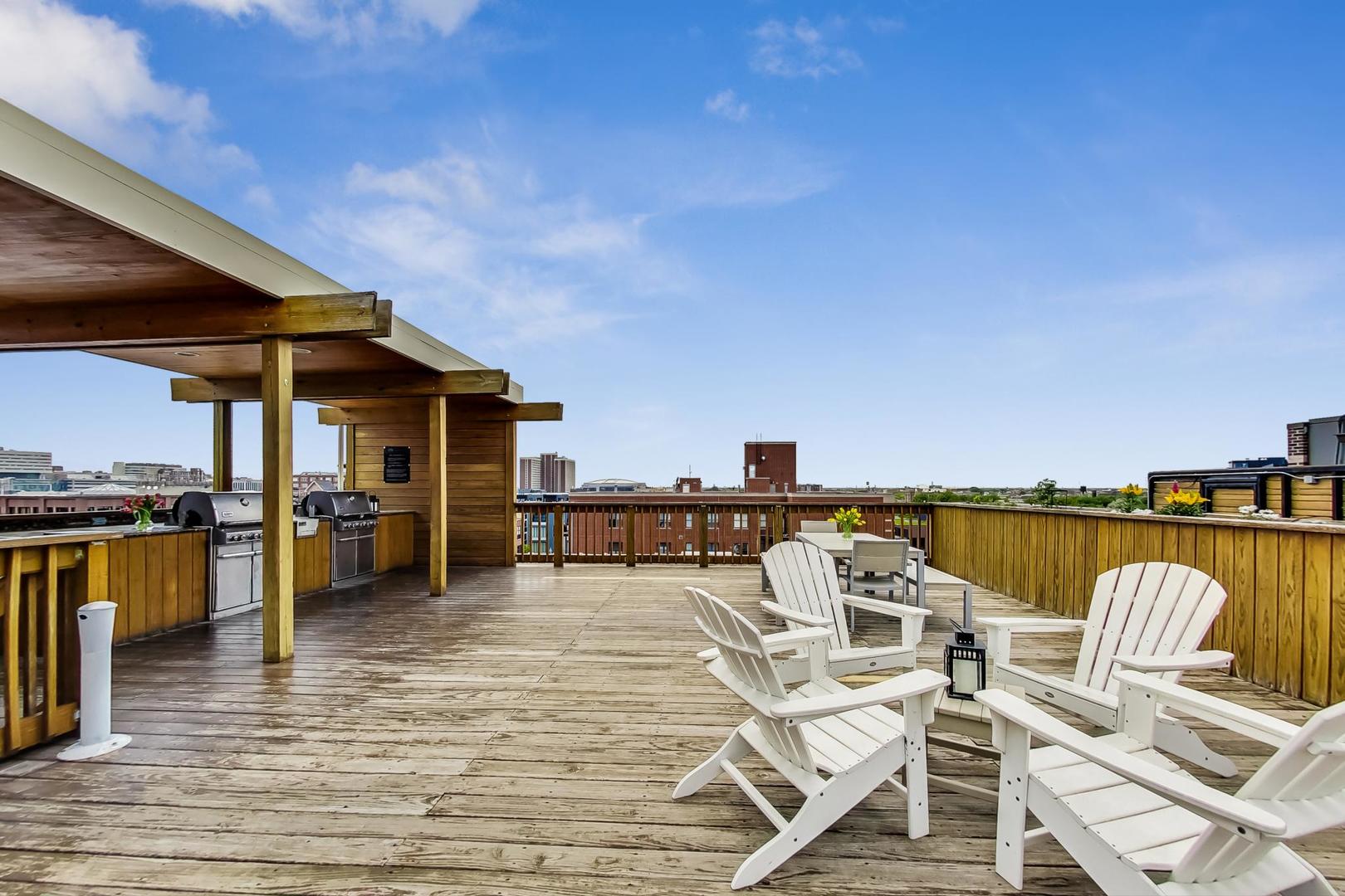 1327 West Washington Boulevard, Unit 2H Chicago, IL 60607 - Photo 26 of 31 a view of a patio with lawn chairs floor to ceiling window and kitchen