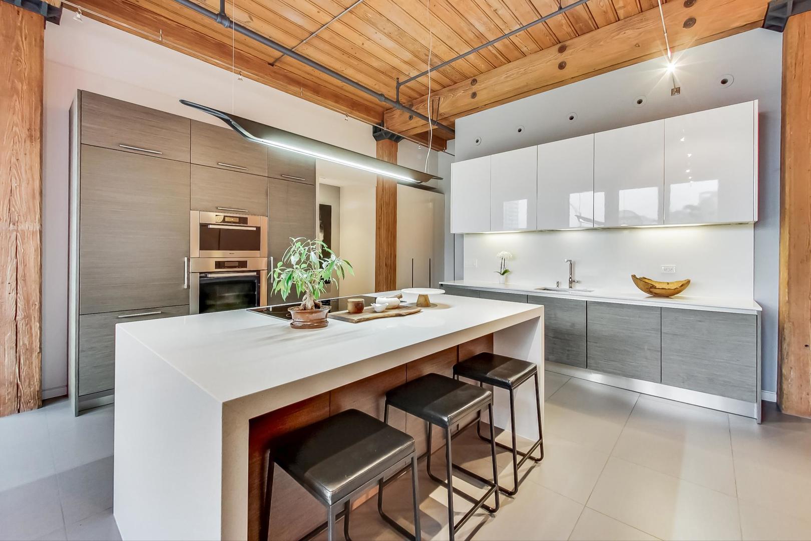 1327 West Washington Boulevard, Unit 2H Chicago, IL 60607 - Photo 6 of 31 a kitchen with a table and chairs in it