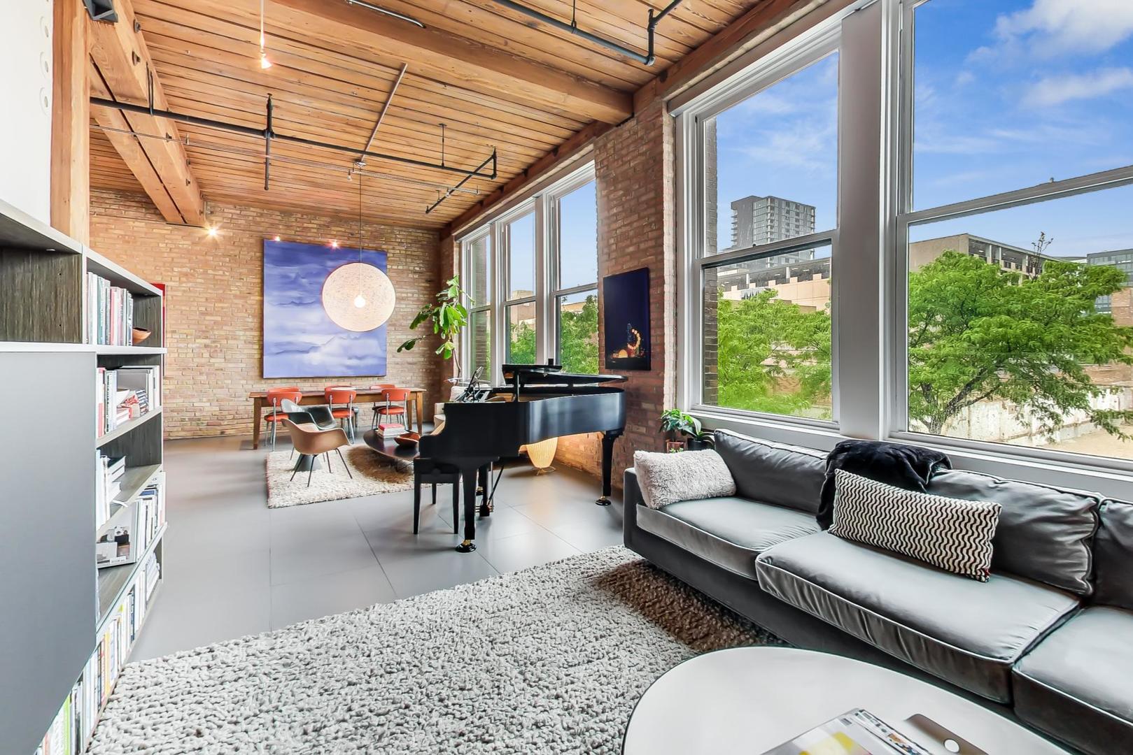 1327 West Washington Boulevard, Unit 2H Chicago, IL 60607 - Photo 10 of 31 a living room with furniture and a large window