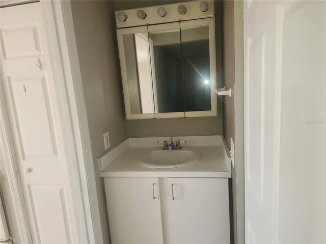 a bathroom with a sink and mirror