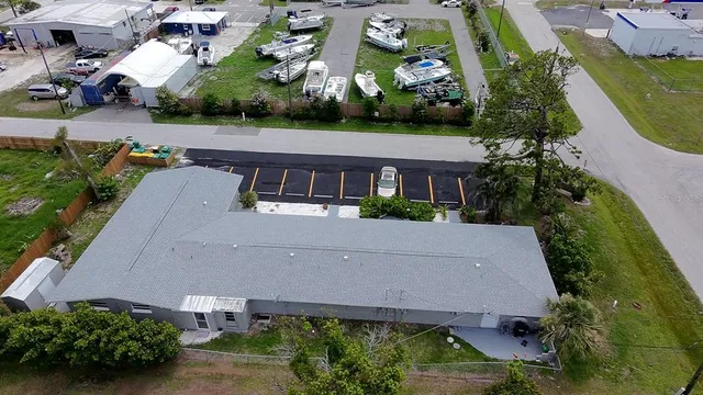 an aerial view of multiple houses with a yard