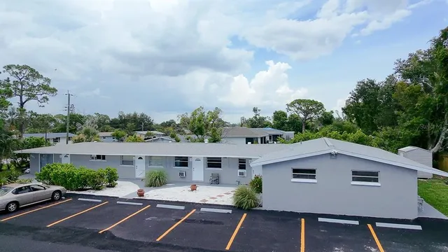 an aerial view of a house with a yard and street view