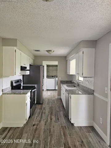 a kitchen with stainless steel appliances granite countertop a stove and a sink