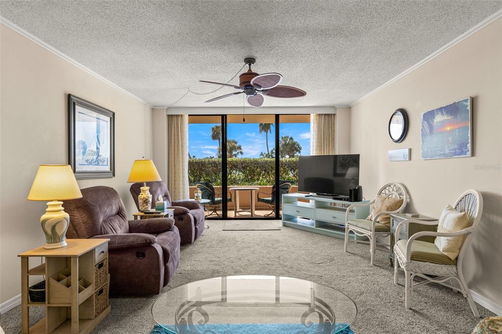 1 Key Capri, Unit 104E Treasure Island, FL 33706 - Photo 16 of 45 a living room with furniture and a flat screen tv