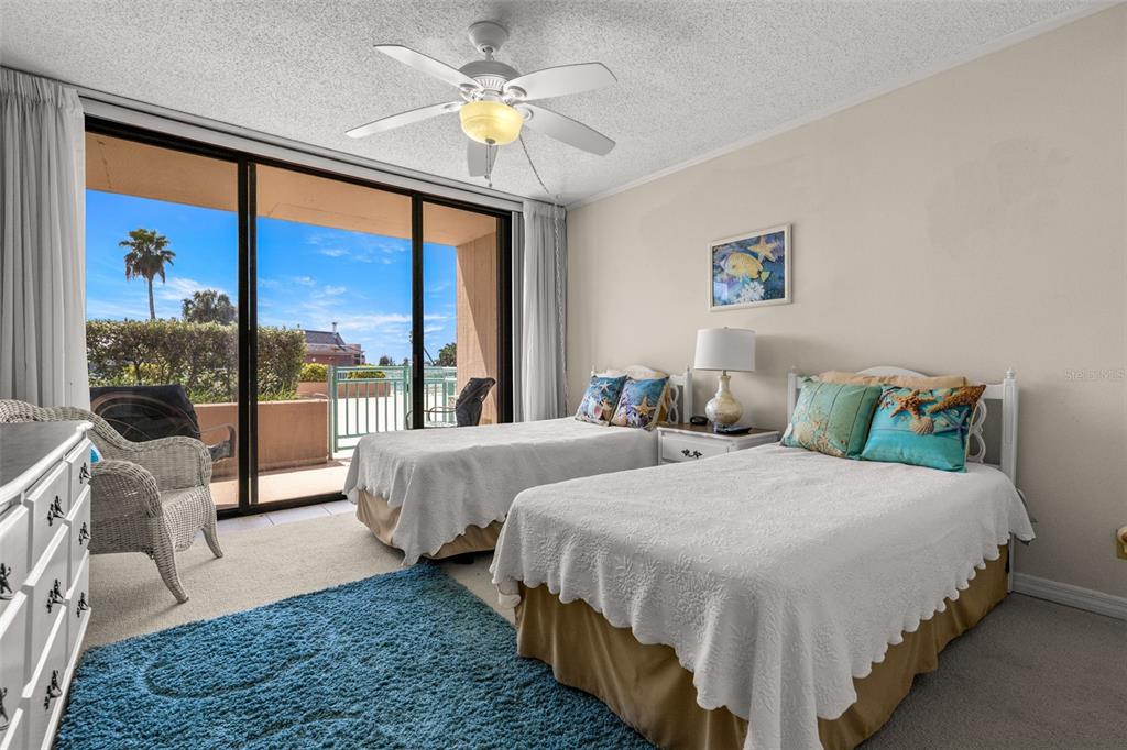 1 Key Capri, Unit 104E Treasure Island, FL 33706 - Photo 23 of 45 a bedroom with two beds and a large window