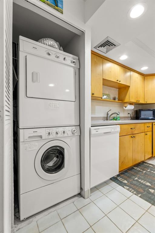 1 Key Capri, Unit 104E Treasure Island, FL 33706 - Photo 26 of 45 a utility room with dryer and washer