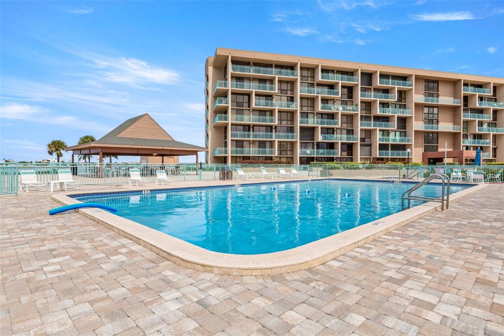 1 Key Capri, Unit 104E Treasure Island, FL 33706 - Photo 31 of 45 a view of swimming pool with a lounge chair