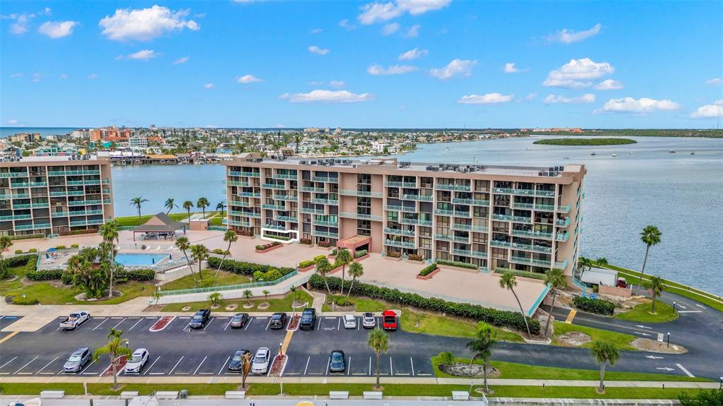 1 Key Capri, Unit 104E Treasure Island, FL 33706 - Photo 36 of 45 swimming pool view with couple of chairs in front of it