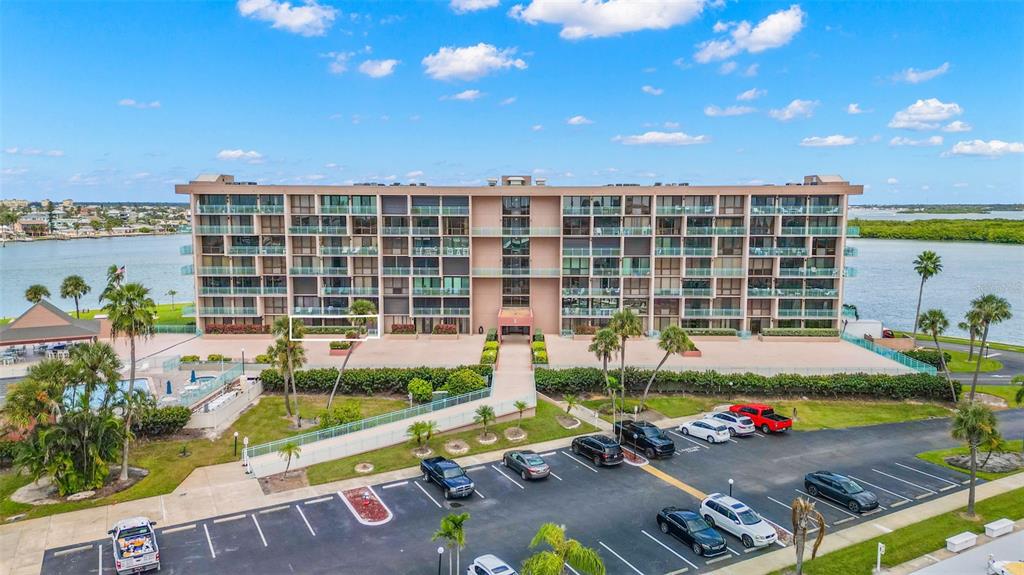 1 Key Capri, Unit 104E Treasure Island, FL 33706 - Photo 38 of 45 a view of a patio with table and chairs and potted plants