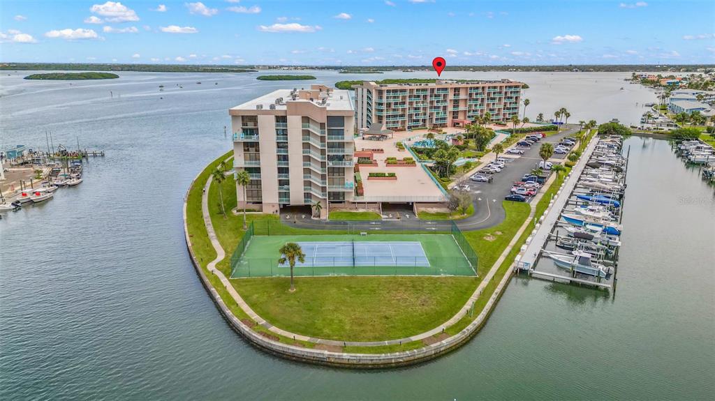 1 Key Capri, Unit 104E Treasure Island, FL 33706 - Photo 40 of 45 an aerial view of a swimming pool with outdoor seating and seating space