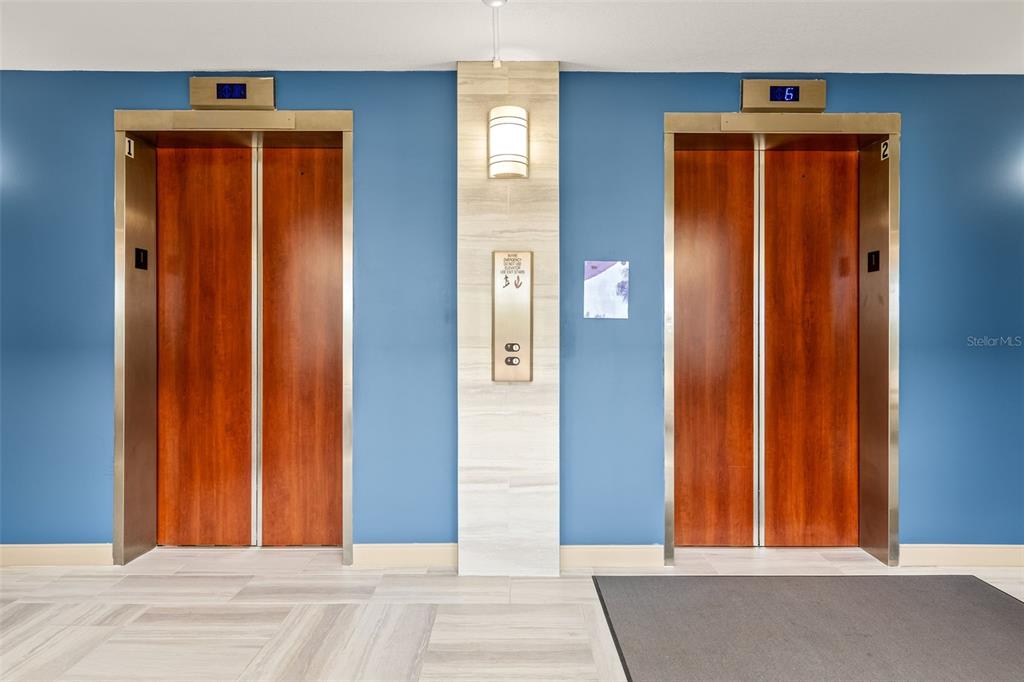 1 Key Capri, Unit 104E Treasure Island, FL 33706 - Photo 4 of 45 a view of a hallway with wooden floor and windows