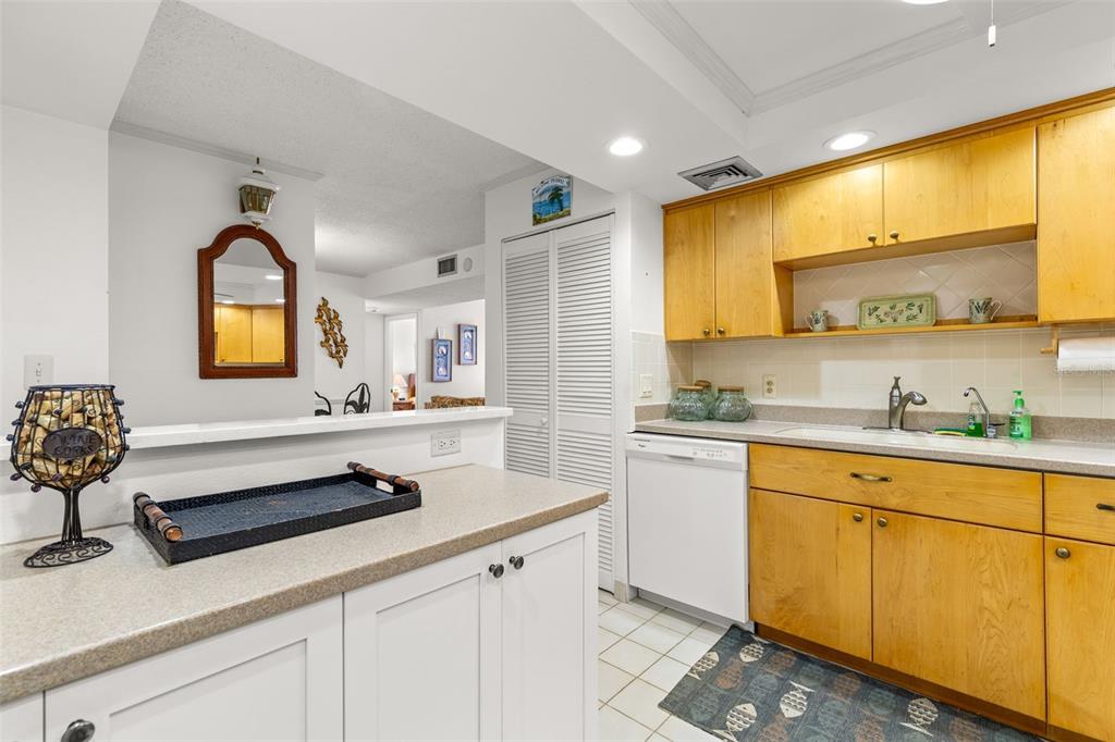 1 Key Capri, Unit 104E Treasure Island, FL 33706 - Photo 9 of 45 a kitchen with stainless steel appliances sink cabinets and window