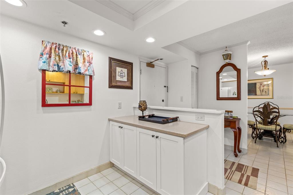 1 Key Capri, Unit 104E Treasure Island, FL 33706 - Photo 10 of 45 a kitchen with a sink window and cabinets