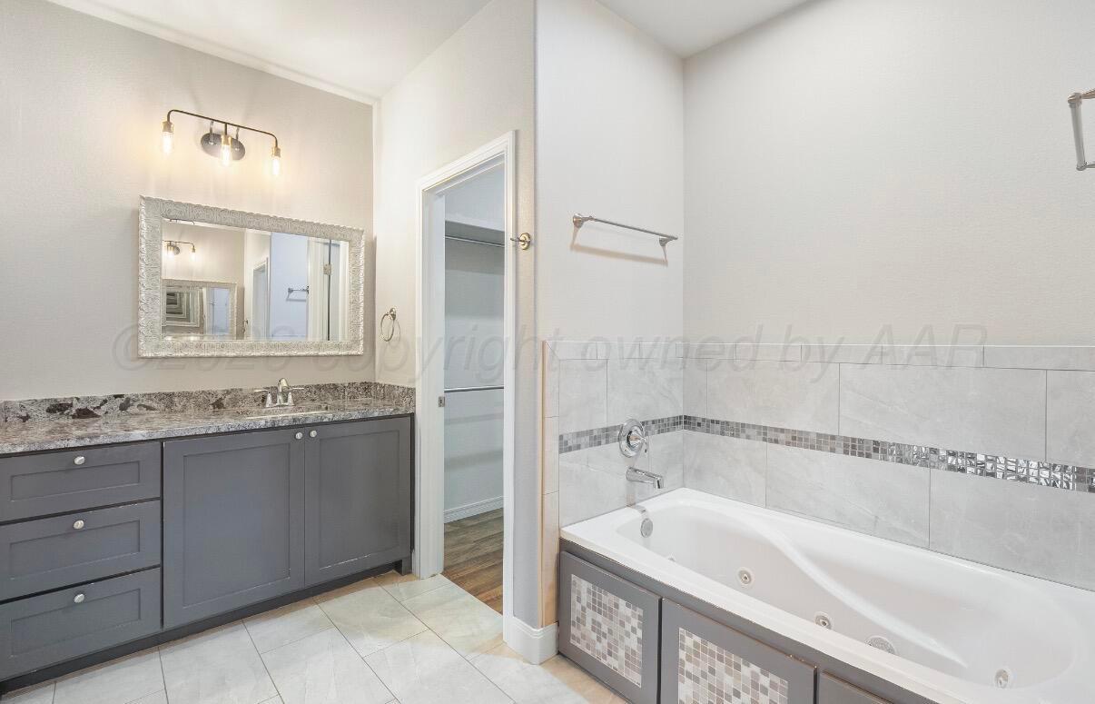 36 Quay Lane Canyon, TX 79015 - Photo 15 of 28 a bathroom with a bathtub and a sink