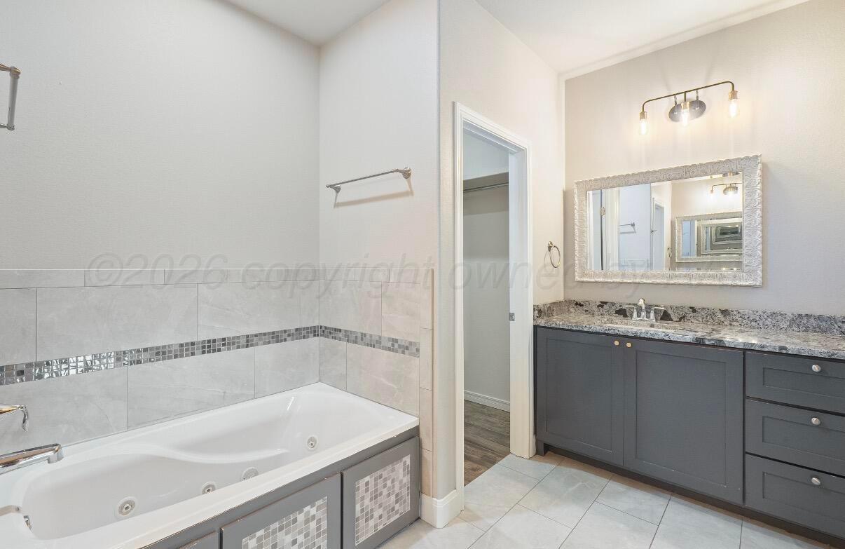 36 Quay Lane Canyon, TX 79015 - Photo 16 of 28 a bathroom with a tub sink and mirror