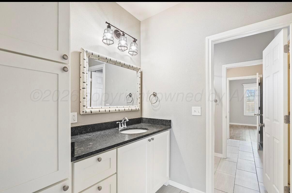 36 Quay Lane Canyon, TX 79015 - Photo 25 of 28 a bathroom with a sink and a mirror