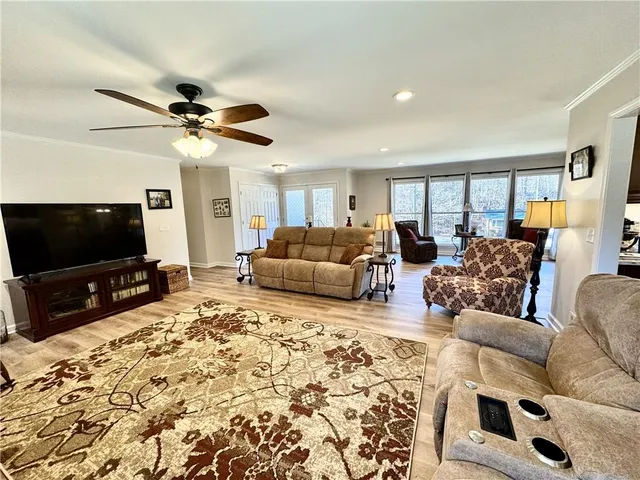a living room with fireplace furniture and a wooden floor
