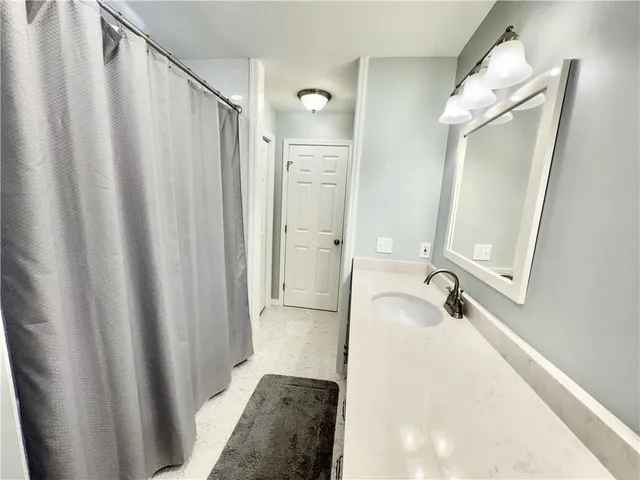 a view of a kitchen with white cabinets