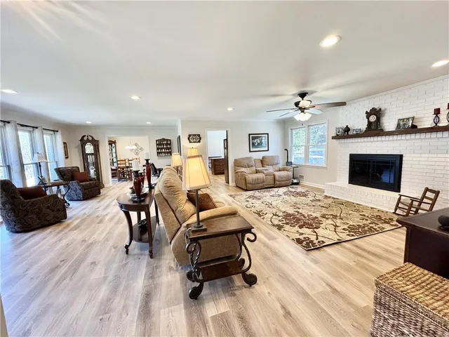a living room with furniture ceiling fan and a rug
