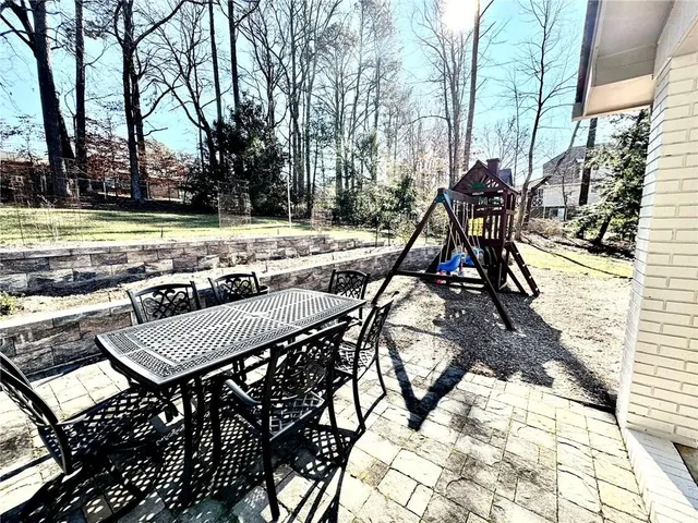 a view of residential houses with yard and ocean view