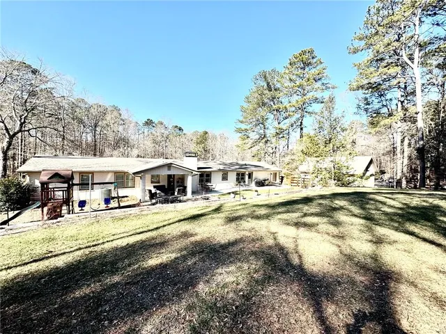 a front view of a house with a yard covered with snow