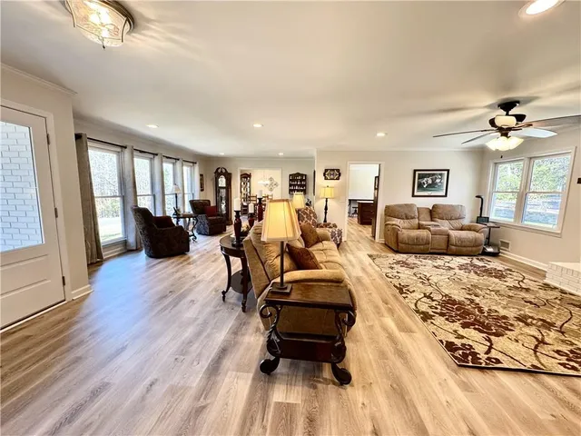 a living room with furniture a couch and a flat screen tv
