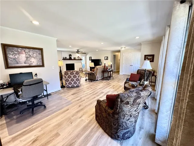 a living room with furniture a flat screen tv and a fireplace