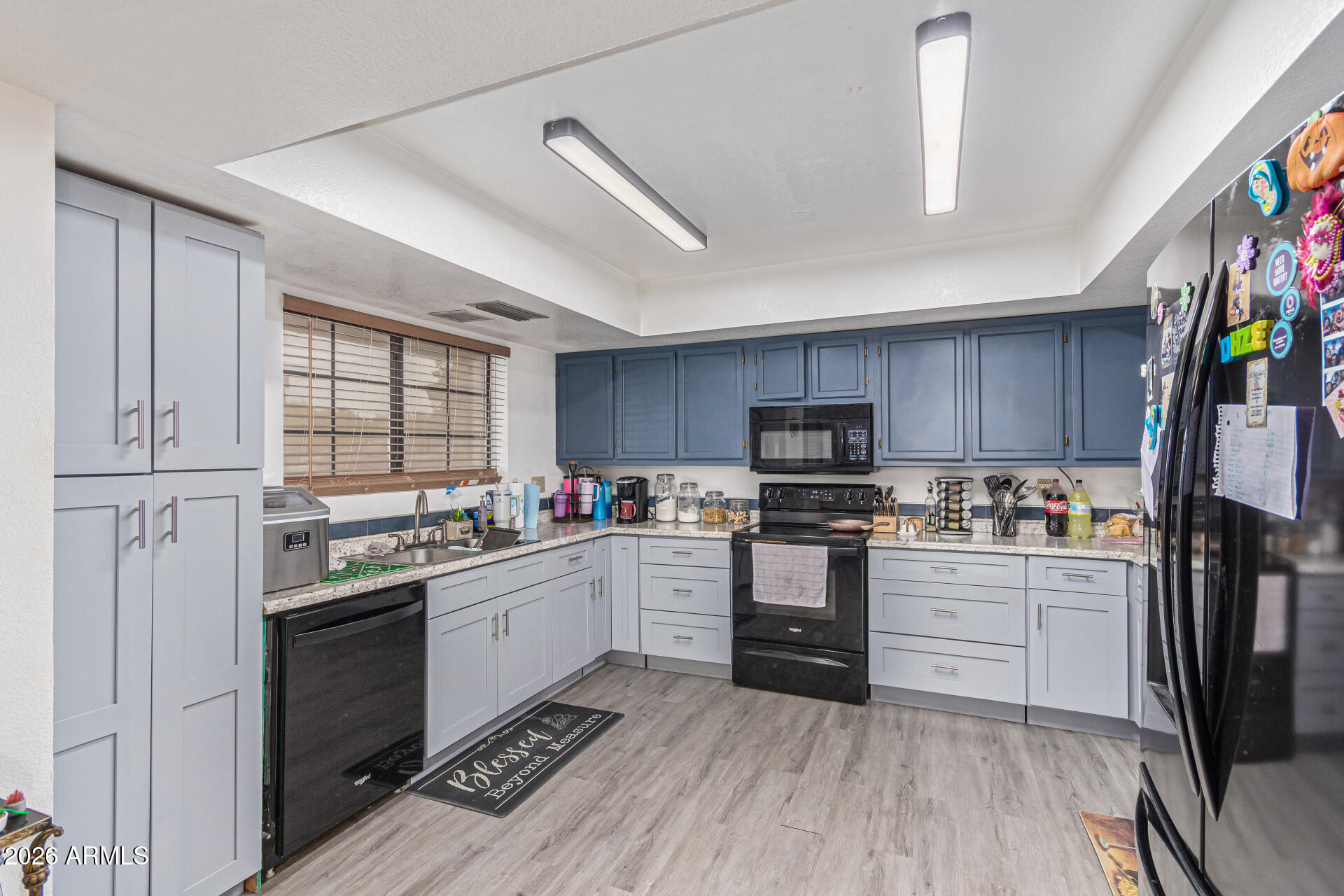 21613 South 154th Street Gilbert, AZ 85298 - Photo 13 of 57 a kitchen with stainless steel appliances granite countertop a stove top oven a sink dishwasher a refrigerator and a refrigerator with wooden floor