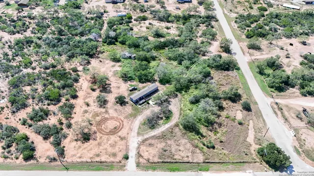 an aerial view of residential houses with outdoor space