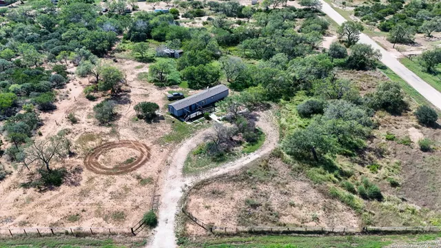 an aerial view of a house with a yard
