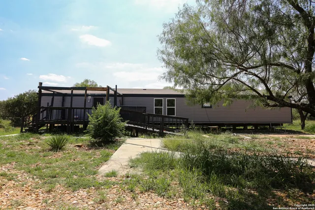 a front view of house with yard and trees