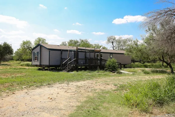 a view of a house with yard and a garden