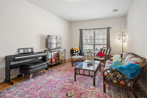 a living room with furniture and a piano
