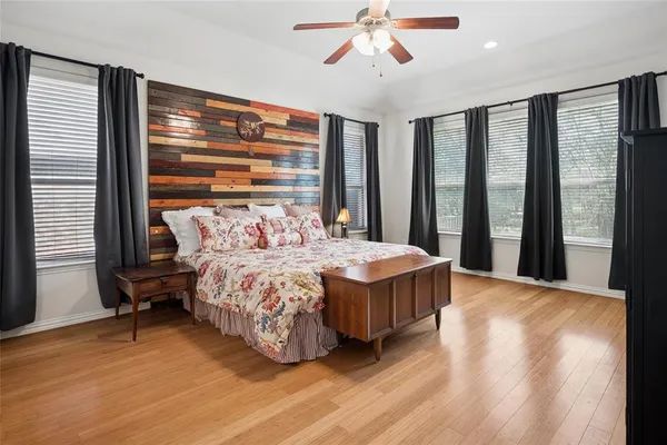 a bedroom with a large bed and a chandelier