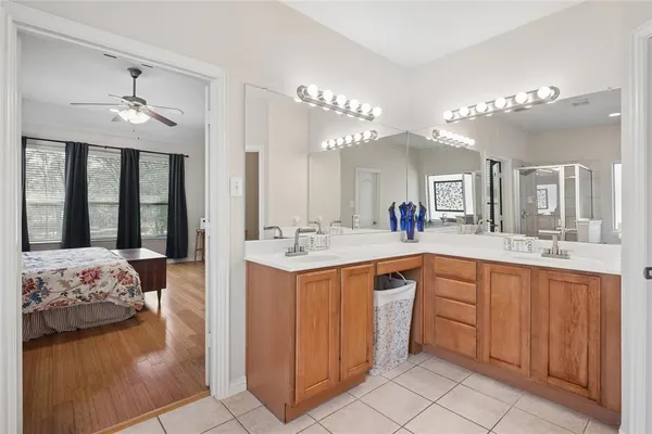 a spacious bathroom with a double vanity sink a mirror and a bathtub