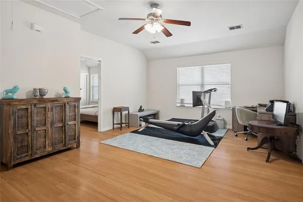 a living room with furniture a ceiling fan and a rug