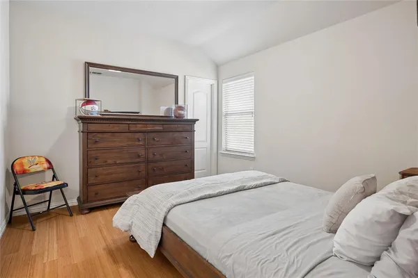 a bedroom with a bed and a tv on dresser