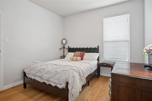 a bedroom with a bed and a desk