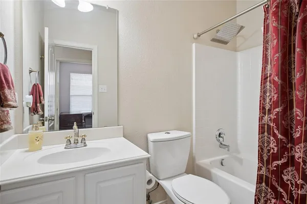 a bathroom with a sink toilet vanity and shower