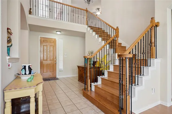 a view of entryway and hall with wooden floor