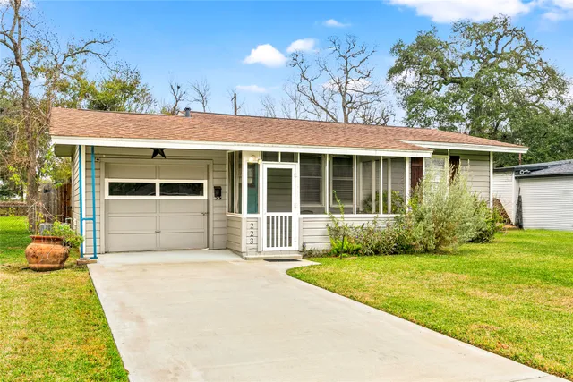 a front view of a house with a garden and yard