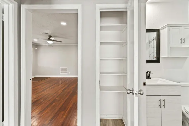 a bathroom with a sink and mirror with shower