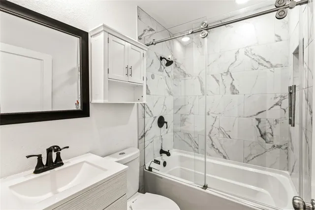 a bathroom with a sink a toilet and a bathtub