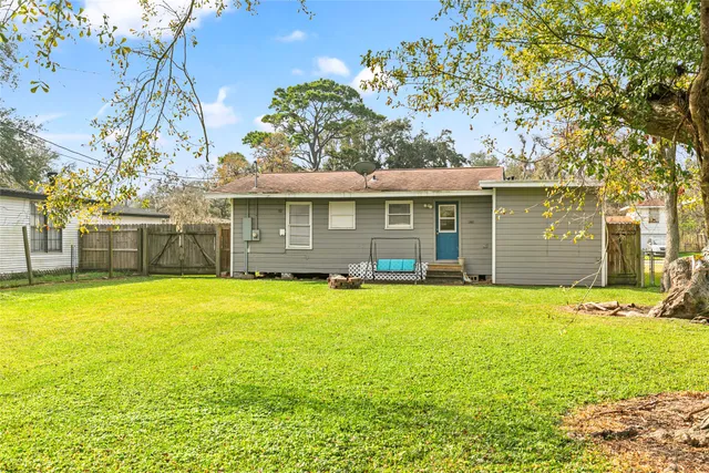 a front view of a house with a garden and yard