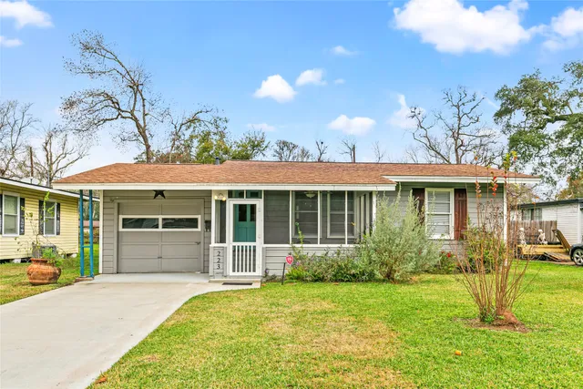 a front view of a house with a garden and plants