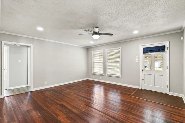 a view of wooden floor and windows in a room